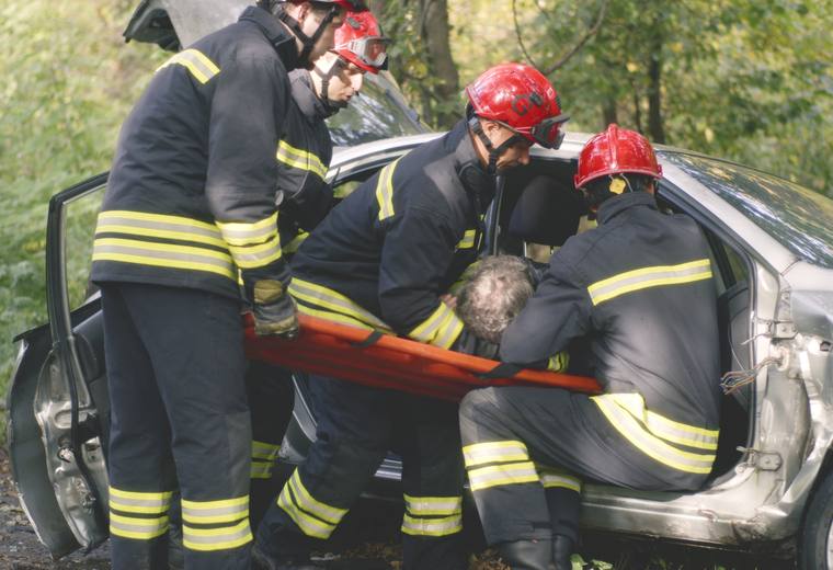 Emergency crews assisting a driver after a collision