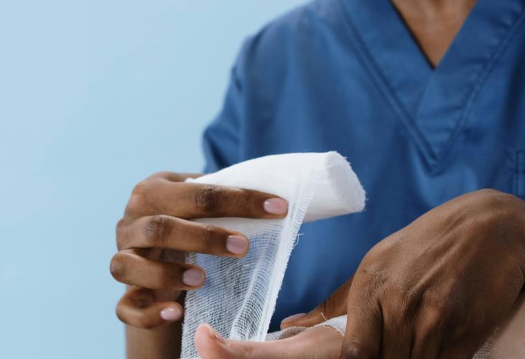 Caregiver treating a patient's injury