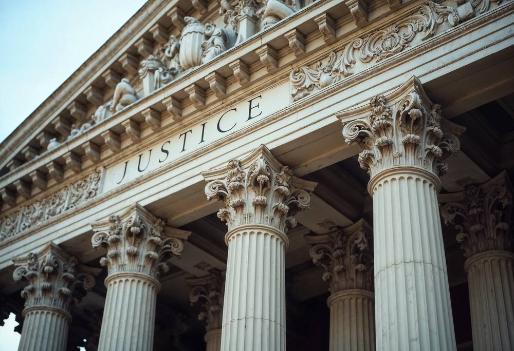 Courthouse facade bearing the word Justice